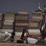 Lawyer-office.-Gavel-Themis-and-legal-books-on-wooden-desk.