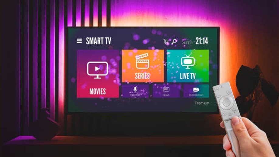 Person using remote with smart TV interface