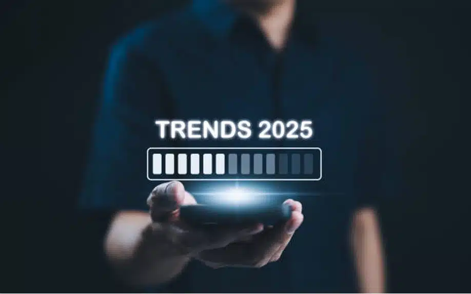 Person holding phone showing 2025 trends loading